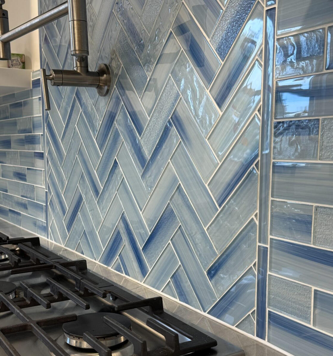 Blue-gray tile backsplash, white cabinets and light kitchen countertop Blue-gray tile backsplash, white cabinets and light kitchen countertop